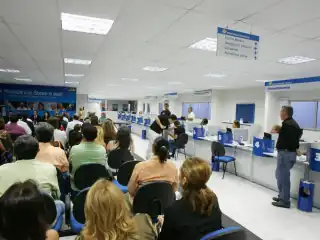 Pessoas sentadas esperando atendimento.