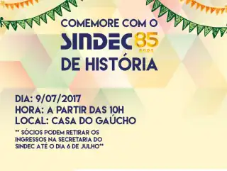 Cartaz com fundo colorido e bandeiras de são joão. Ao centro em destaque: 'comemore com o Sindec 85 anos de história'